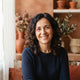 Portrait of a happy middle-aged Spanish woman smiling, used to represent a satisfied customer.